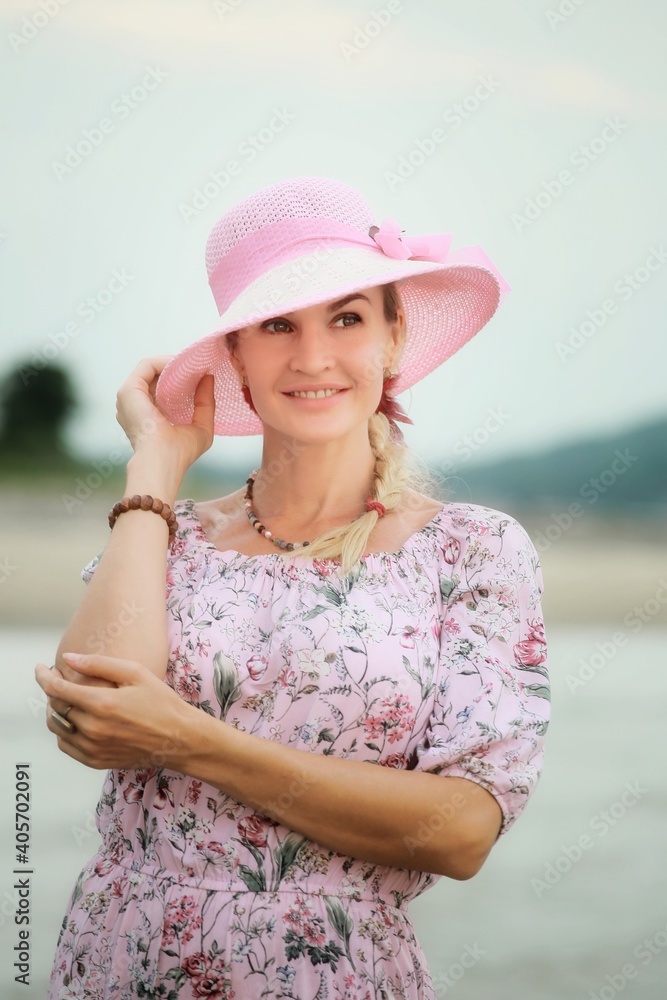 A girl in a pink dress and a pink hat