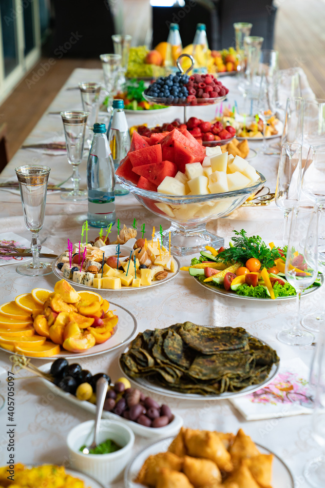 table served with light summer snacks-fruits, vegetables, berries. catering table served with light summer snacks-fruits, vegetables, berries. catering