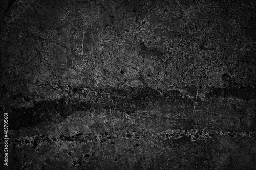 Black grunge background. Old concrete wall texture. Cracked damaged wall. Distressed gothic dark rough backdrop with copy space for your design.
