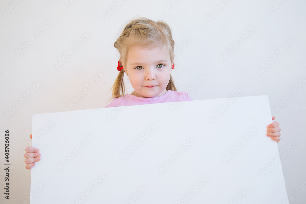 three-year-old charming girl holding a piece of paper three-year-old charming girl holding a piece of paper