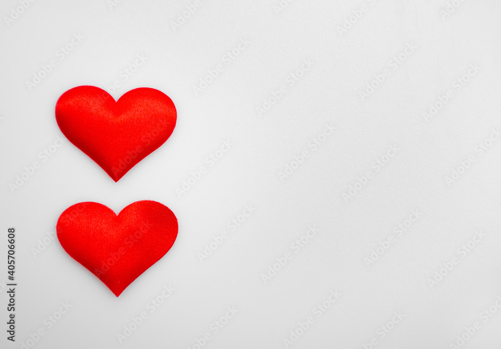 Two textured red hearts on top of each other on a white or gray background: place for text, St. Valentine's Day background, minimalism 