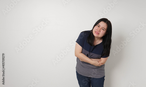 Asian woman unhappy looking sick, suffers from stomach ache stomachache isolated white background because of menstruation and eating spoiled food, Chronic gastritis. Abdomen bloating concept