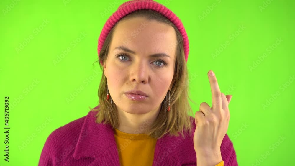 Serious Woman In Red Coat And Hat Defiantly Shows Middle Finger. Indecent Hand Gesture. Emotions of Aggression, Anger. Serious Facial Expression. Green Background, Studio Video, 4K, Chroma Key. Serious Woman In Red Coat And Hat Defiantly Shows Middle Finger. Indecent Hand Gesture. Emotions of Aggression, Anger. Serious Facial Expression. Green Background, Studio Video, 4K, Chroma Key.