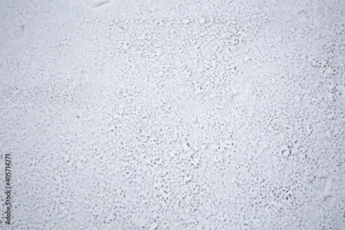Snow texture on the asphalt. Winter background