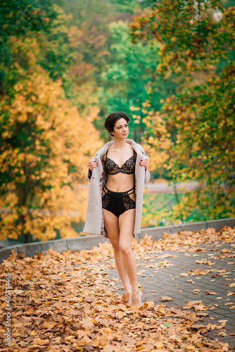 Fototapeta Naklejka Na Ścianę i Meble -  Beautiful young woman in lingerie in autumn forest