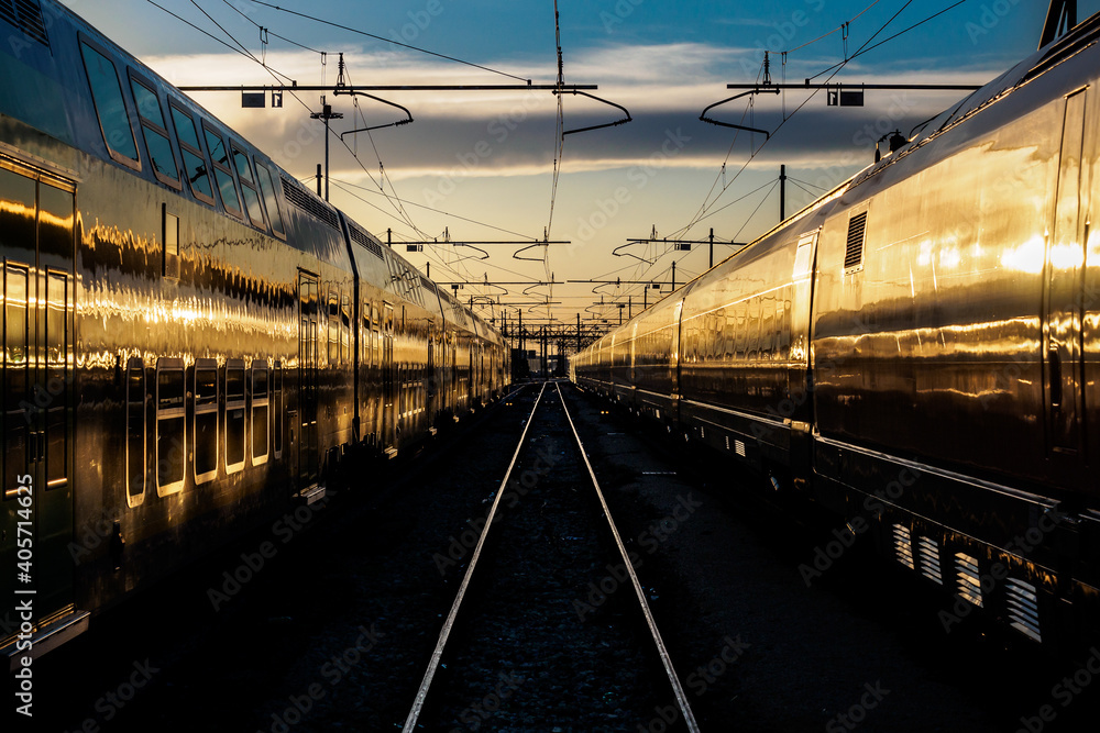 view of trains at train station at sunset