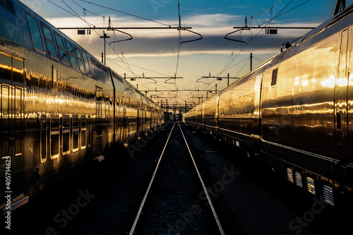 Fotografie view of trains at train station at sunset