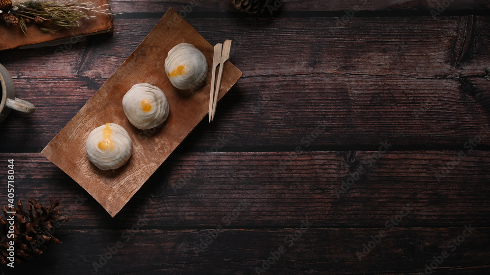 Top view of Chinese pastry or moon cake on wood dish and wood table with copy space. Top view of Chinese pastry or moon cake on wood dish and wood table with copy space.