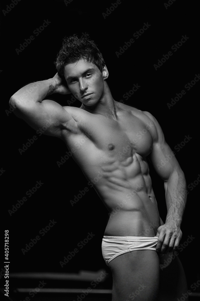 black and white strong man in the underwear showing his muscles black and white strong man in the underwear showing his muscles