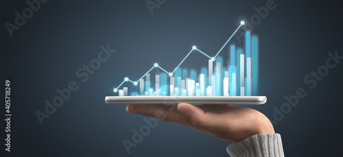 Businessman plan graph growth increase of chart positive indicators in his business,tablet in hand