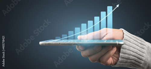 Hand holding smartphone device and touching screen. Stock exchange market concept