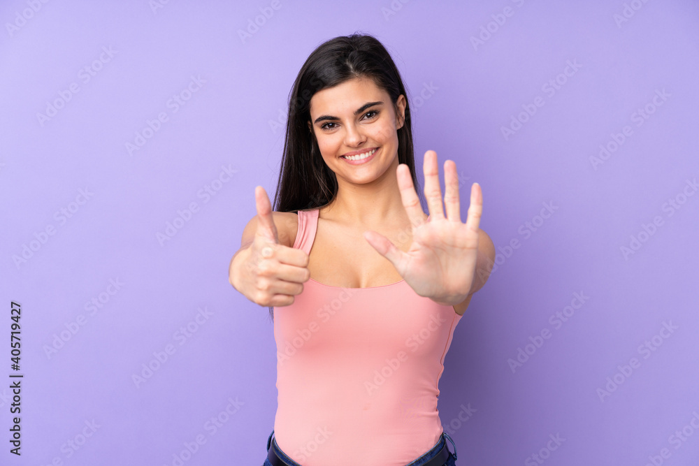 Young woman over isolated purple background counting six with fingers Young woman over isolated purple background counting six with fingers