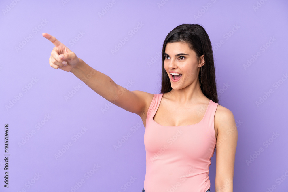 Young woman over isolated purple background pointing away Young woman over isolated purple background pointing away