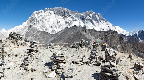 View from top of Chhukung hill over Lhotse wall with rock cairns in the foreground, Everest Base Camp trek, Nepal