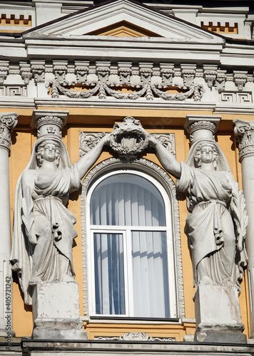 Decoration of the facade of the building with sculptures and busts of Atlantes photo