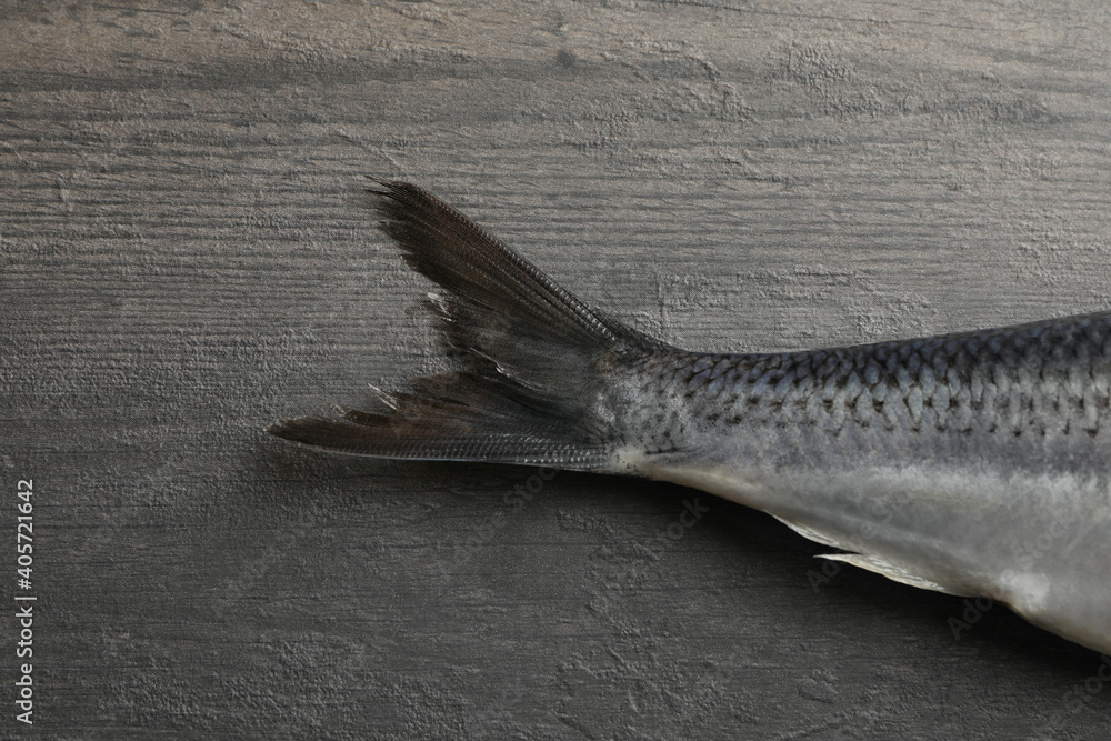 Herring fish tail on gray wooden background Herring fish tail on gray wooden background