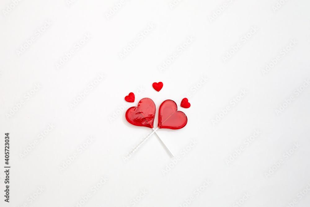 two red Valentine's day heart shape lollipop candy on empty white paper background. Love Concept. top view. Minimalism colorful hipster style. banner two red Valentine's day heart shape lollipop candy on empty white paper background. Love Concept. top view. Minimalism colorful hipster style. banner