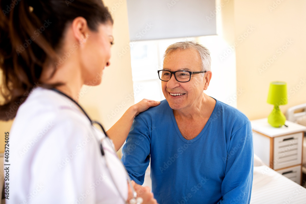 Obraz premium Nursing home doctor providing care to a senior man resident