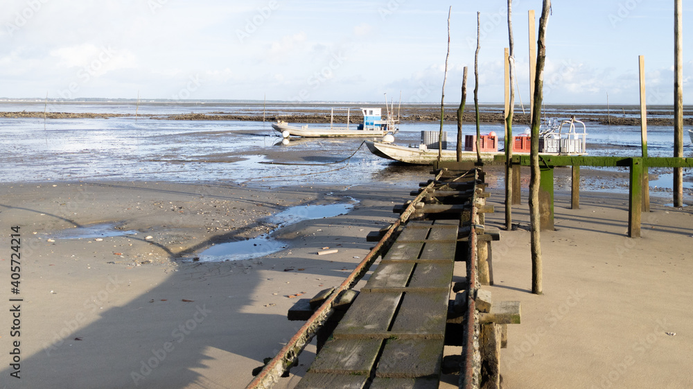 boat oysters at low tide in bay Arcachon beach France in Le Canon oyster farm Village