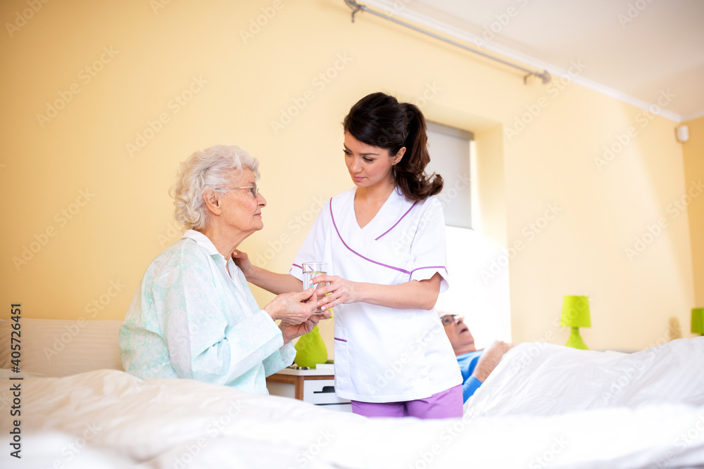 Fototapeta premium Two ladies working together, doctor and her nursing facility patient