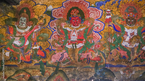 Colorful wall painting at the entrance of historical Jampey lhakhang temple complex in Bumthang valley, Bhutan representing the guardians of the cardinal directions