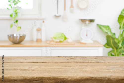 Wood table top on blur kitchen room counter background