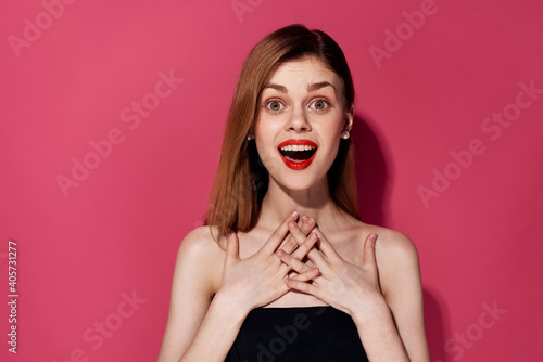 Pretty woman surprised look red lips nude shoulders studio pink backgrounds