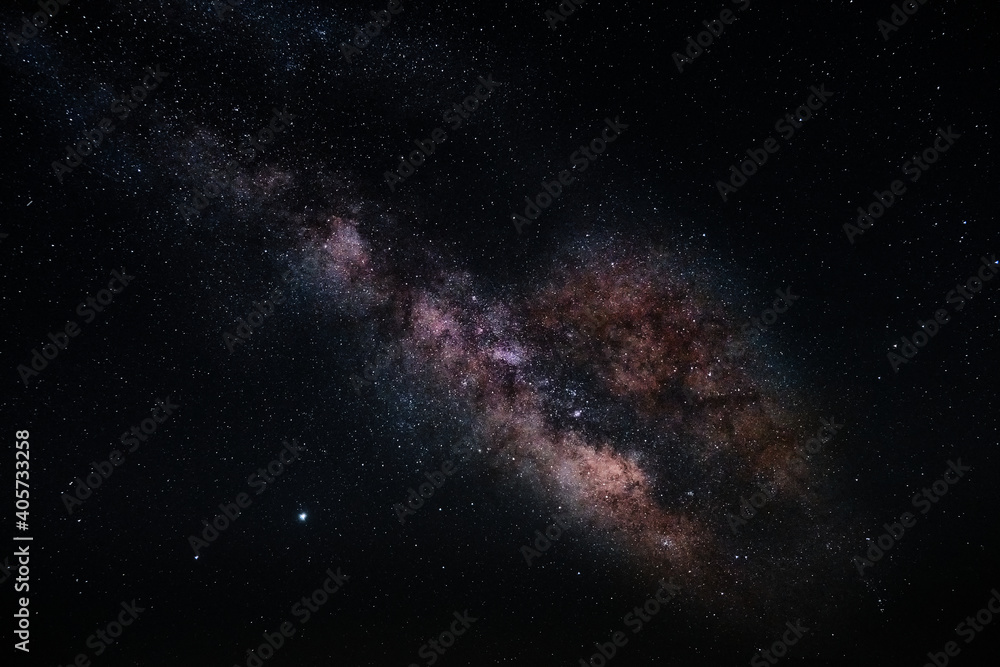 Fototapeta premium Milky way surrounded by a dark night sky