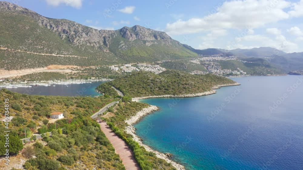 The road runs along the coast peninsula Kas town on gorgeous setting a beautiful cove, charming nature and mountains in Antalya, Turkey. Aerial view 4K. The road runs along the coast peninsula Kas town on gorgeous setting a beautiful cove, charming nature and mountains in Antalya, Turkey. Aerial view 4K.