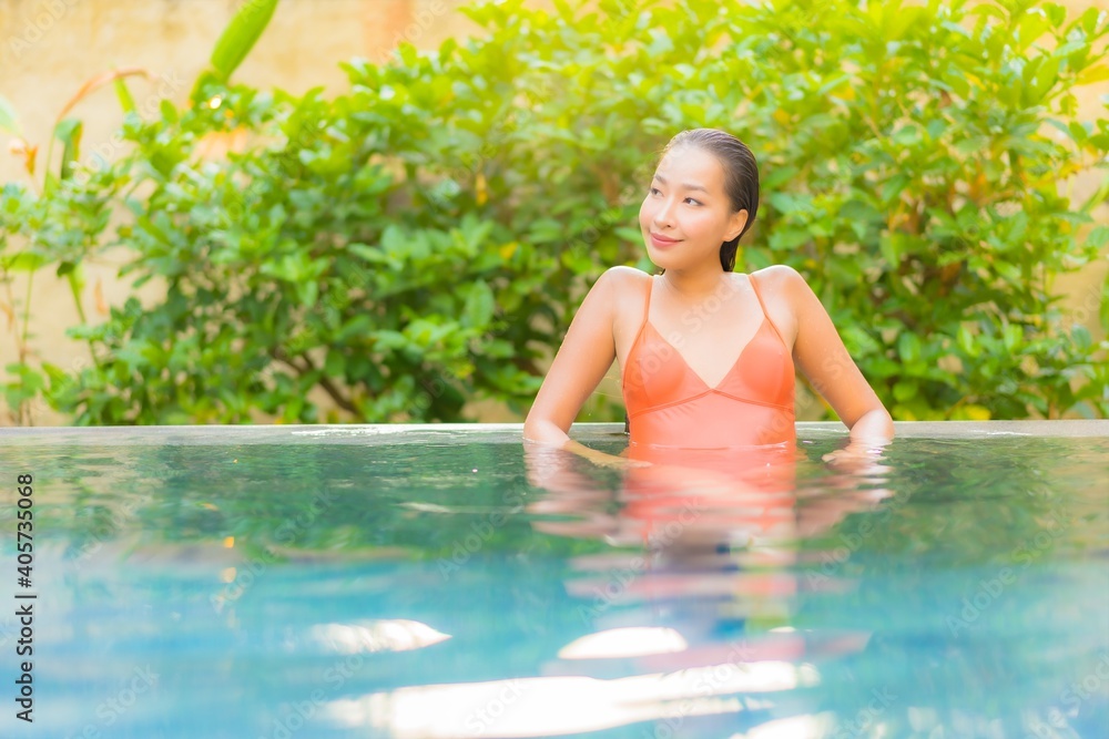 Portrait beautiful young asian woman enjoy relax around swimming pool