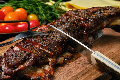 Grilled lamb breast and flap on wooden cutting board