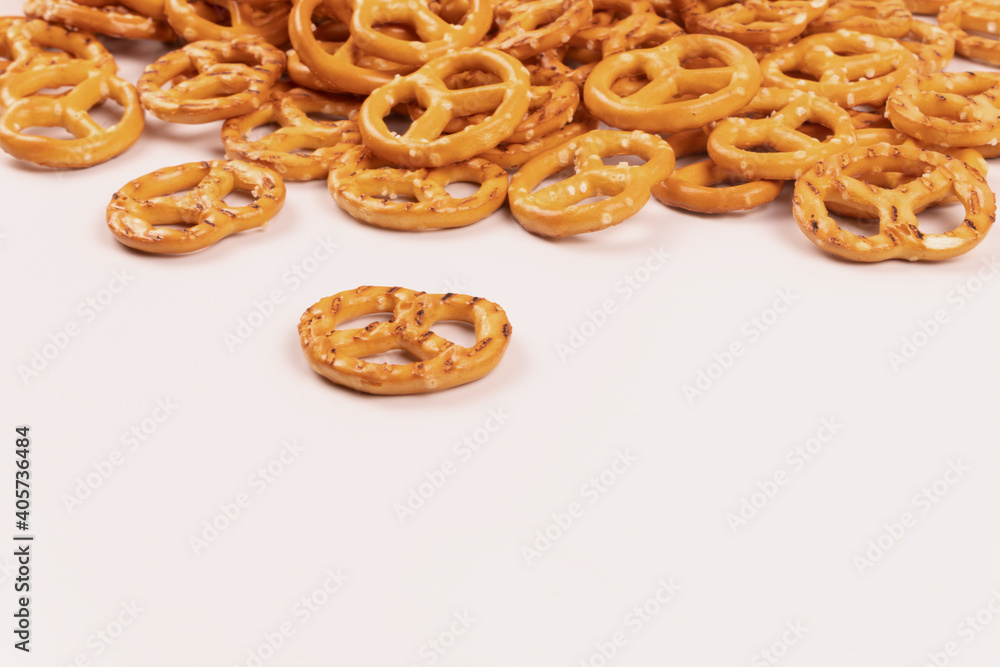 yellow pretzels stacked in a heap on the far side yellow pretzels stacked in a heap on the far side