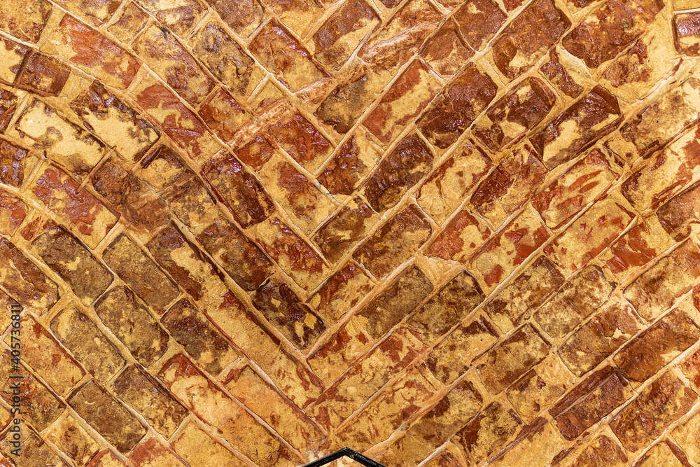 Obraz premium Abstract fragment of an old unpainted brick wall. The concept of an old brick wall with a cracked surface that is used as a background.