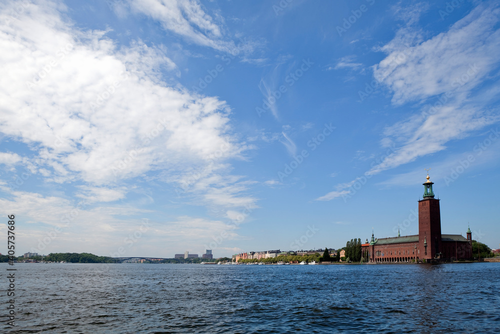 Panorama view over Stockholm City Hall on Kungsholmen Island. Summer day with a blue cloudy sky.