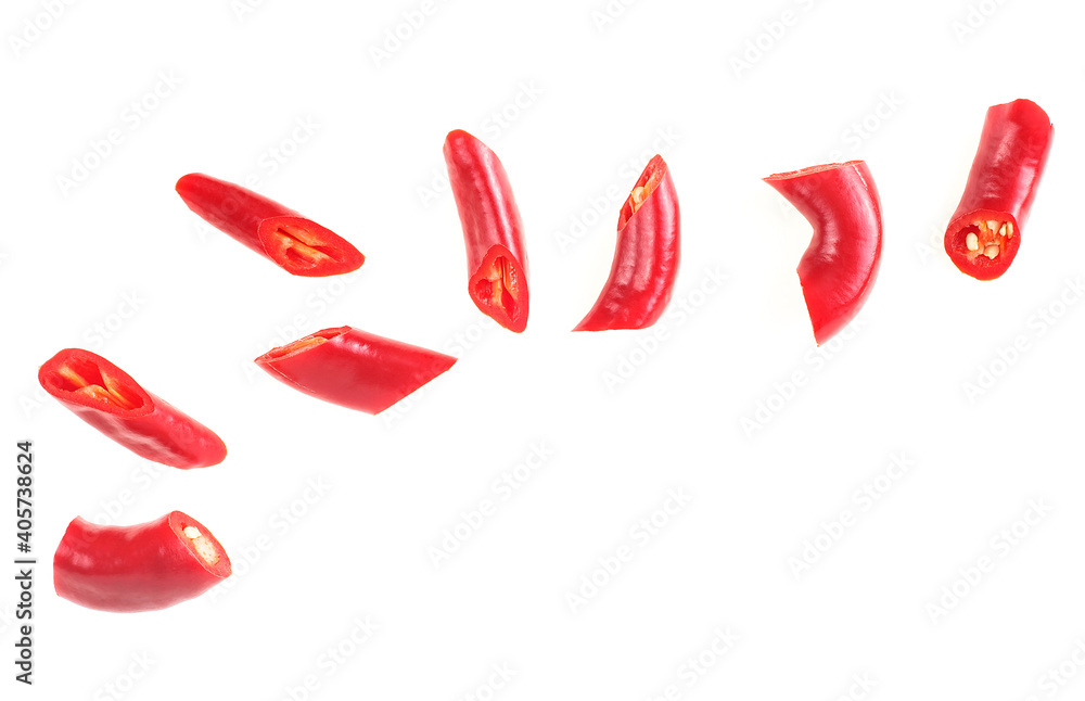 Red chopped chili peppers isolated on a white background, top view. Red pepper slices. Red chopped chili peppers isolated on a white background, top view. Red pepper slices.