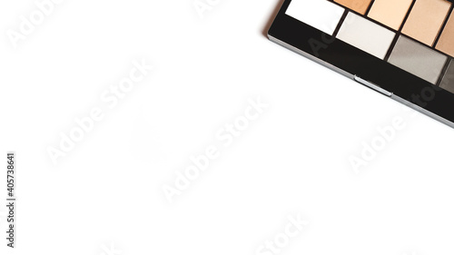 neutral brown eye shadow palette on white background. Female decorative cosmetics. Close up. Copy space. Flat lay