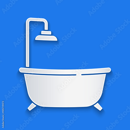 Paper cut Bathtub with shower icon isolated on blue background. Paper art style. Vector.