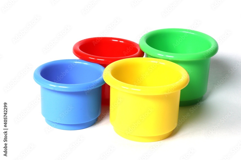 Four multicolored kids beach buckets on an isolated white background. Beach forms for children to play Four multicolored kids beach buckets on an isolated white background. Beach forms for children to play
