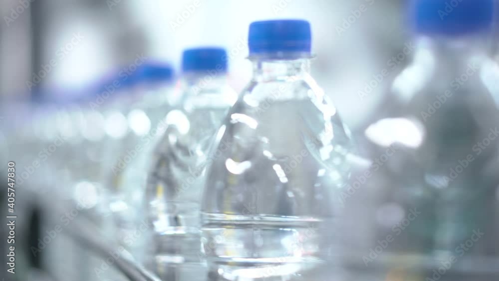 Plastic water bottles on conveyor and water bottling machine industry. Plastic water bottles on conveyor and water bottling machine industry.