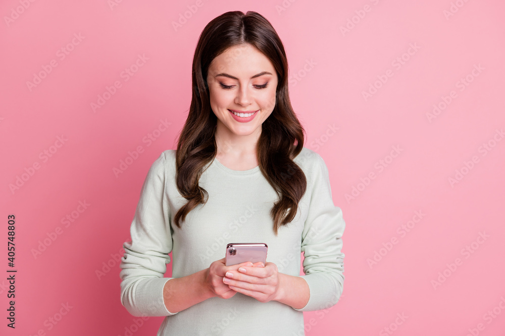 Photo of charming wavy hairdo person look phone screen toothy smile isolated on pink color background Photo of charming wavy hairdo person look phone screen toothy smile isolated on pink color background