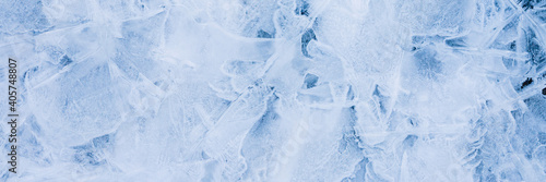 Ice texture. Beautiful winter frosty background. Cool ice patterns on the frozen surface of the water. Cold weather and frost. Winter season. Wide panoramic texture for background and design.