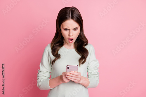 Portrait of impressed lady open mouth staring screen disbelief unfollow isolated on pink color background