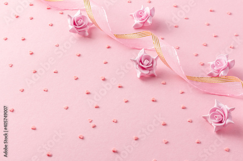 Pink background with candy hearts sweet flowers and ribbon for Valentine day, wedding, dating or mothers day