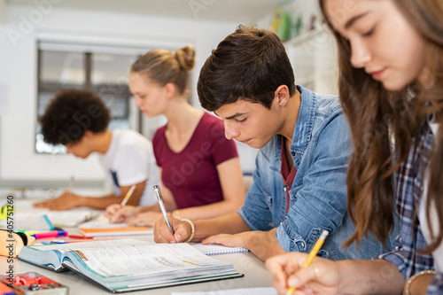 High school students doing exam in classroom photo