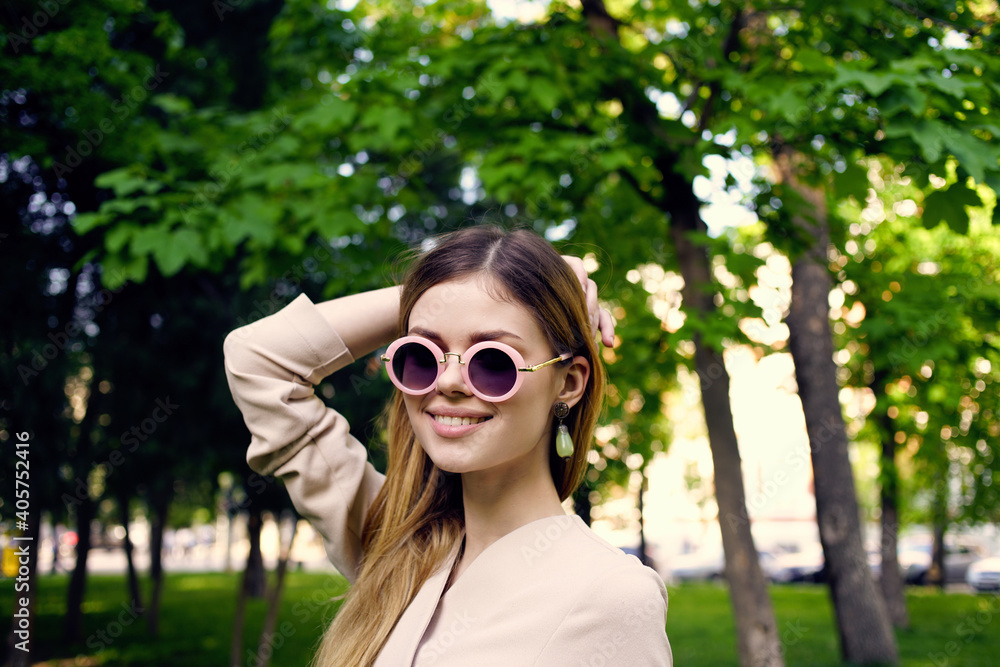 Pretty woman in sunglasses outdoors in green trees park travel Pretty woman in sunglasses outdoors in green trees park travel