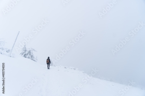 Person in the middle of a blizzard  minimalist photo with intentional overexposure.