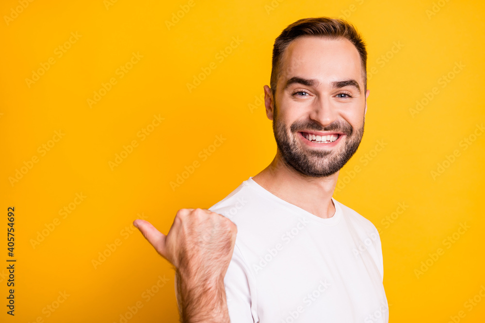 Profile portrait of optimistic cool guy point back empty space wear white t-shirt isolated on vibrant yellow color background Profile portrait of optimistic cool guy point back empty space wear white t-shirt isolated on vibrant yellow color background