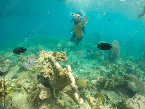 woman snorkeling with fish. Underwater moment © HumbaFrame