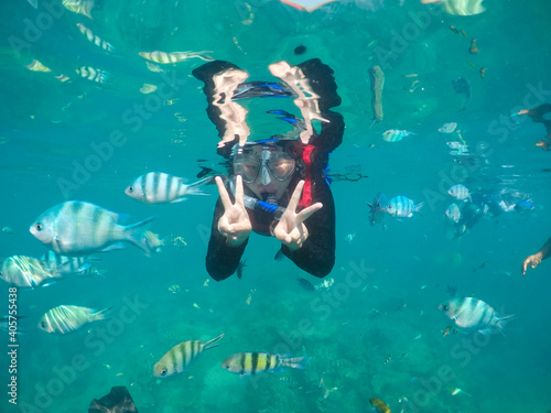 woman snorkeling with fish. Underwater moment