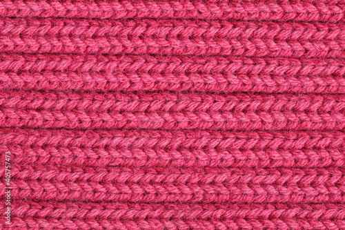 Texture of a red knitted sweater fabric.